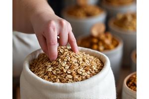 Ręka nabierająca ziarna do wielorazowego woreczka w sklepie z artykułami sypkimi, symbolizująca zakupy hurtowe.